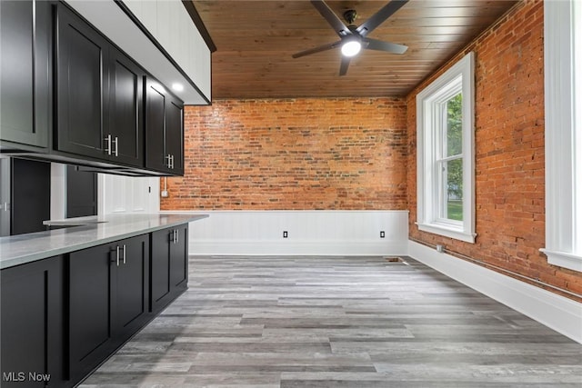 638 High St, Wooster, OH 44691 - kitchen with wood ceiling, brick wall, dark cabinets, ceiling fan, and light wood-style floors