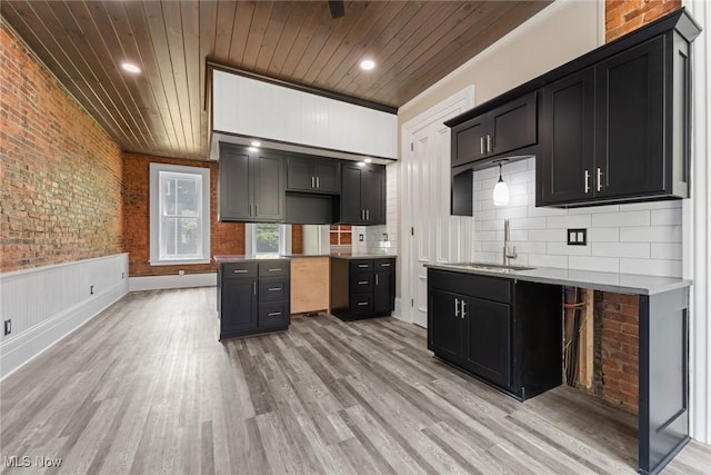 638 High St, Wooster, OH 44691 - kitchen with wood ceiling, light wood finished floors, dark cabinetry, backsplash, and brick wall