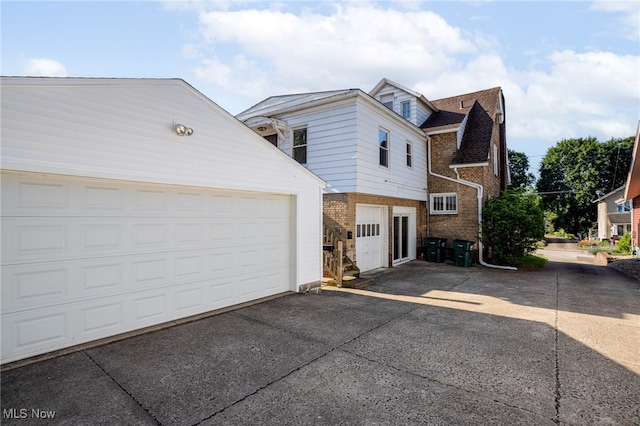 289 E Baird Ave, Barberton, OH 44203 - view of property exterior with brick siding, a garage, driveway, and an outdoor structure