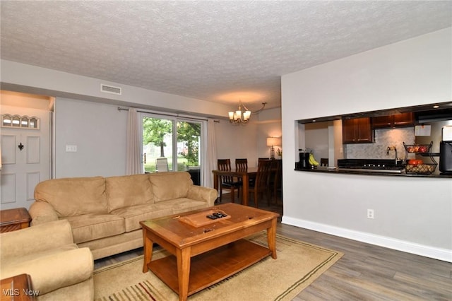 4914 Independence Cir Unit D, Stow, OH 44224 - living area featuring wood finished floors, a chandelier, and a textured ceiling