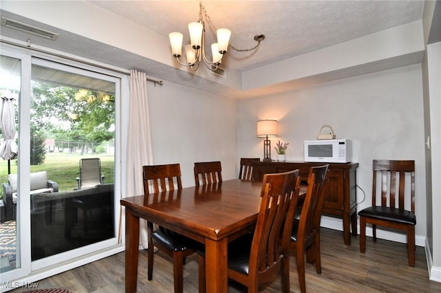 4914 Independence Cir Unit D, Stow, OH 44224 - dining area featuring a chandelier, wood finished floors, and a textured ceiling