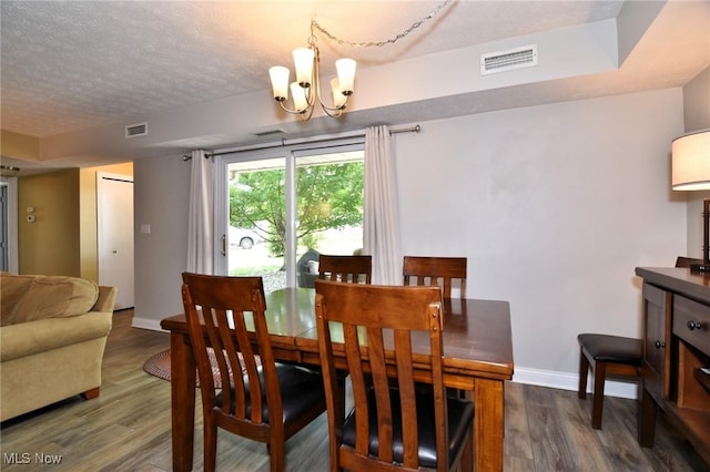 4914 Independence Cir Unit D, Stow, OH 44224 - dining room with a chandelier, wood finished floors, and a textured ceiling