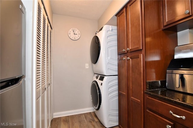 4914 Independence Cir Unit D, Stow, OH 44224 - laundry room featuring stacked washer and clothes dryer and wood finished floors