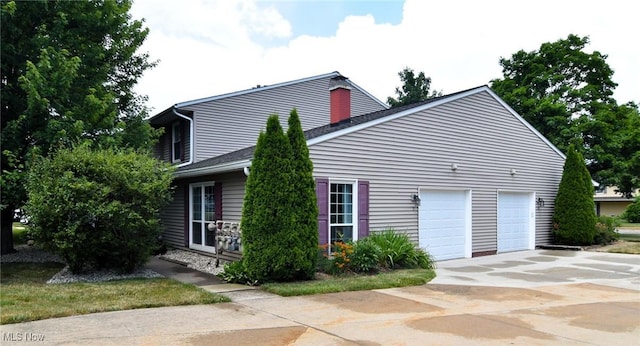 4914 Independence Cir Unit D, Stow, OH 44224 - view of side of home featuring concrete driveway and an attached garage