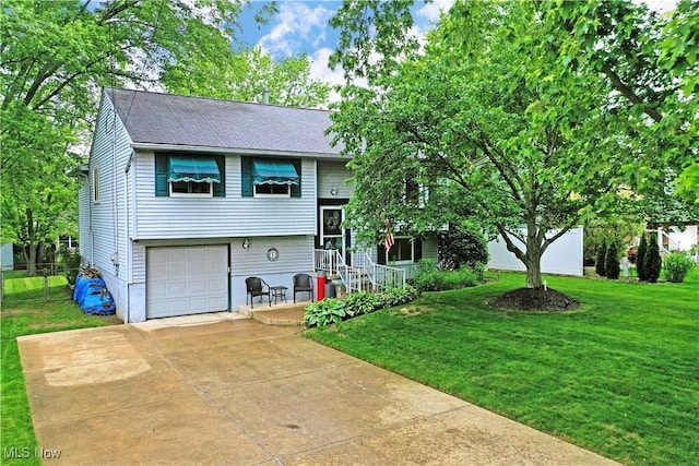 2555 Walnut St, Girard, OH 44420 - view of front of home featuring a front yard, concrete driveway, an attached garage, and roof with shingles