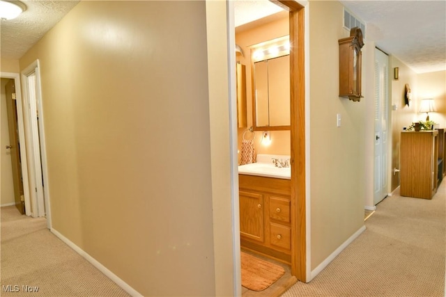 2555 Walnut St, Girard, OH 44420 - hallway featuring light colored carpet and a textured ceiling