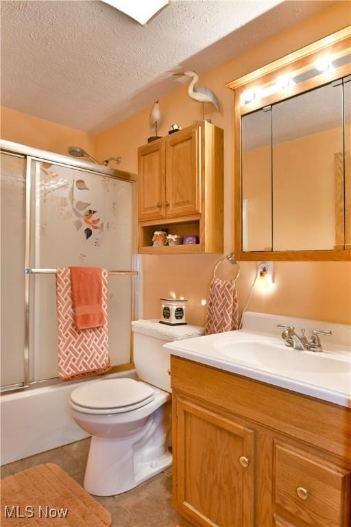 2555 Walnut St, Girard, OH 44420 - bathroom featuring vanity, a textured ceiling, enclosed tub / shower combo, and tile patterned flooring