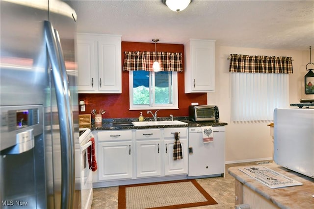 2555 Walnut St, Girard, OH 44420 - kitchen with stainless steel fridge with ice dispenser, dishwasher, white cabinetry, dark countertops, and a textured ceiling
