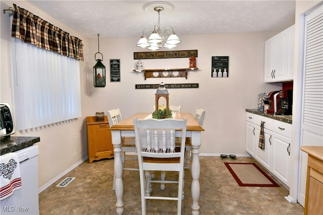 2555 Walnut St, Girard, OH 44420 - dining area featuring a textured ceiling and a chandelier