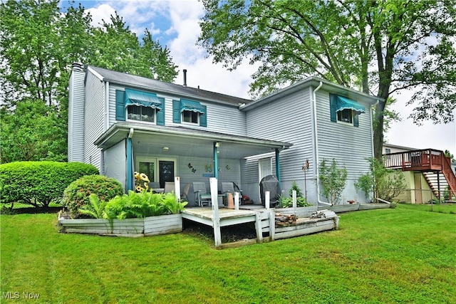 2555 Walnut St, Girard, OH 44420 - back of house featuring a chimney, a lawn, a deck, and stairs