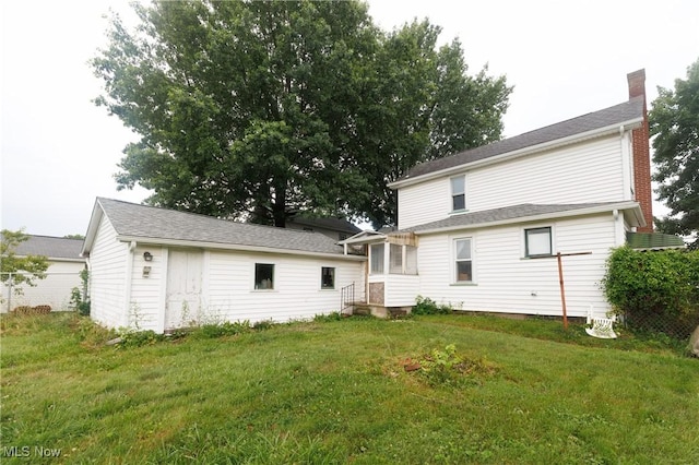 625 W Church St, Orrville, OH 44667 - back of house featuring a chimney and a lawn