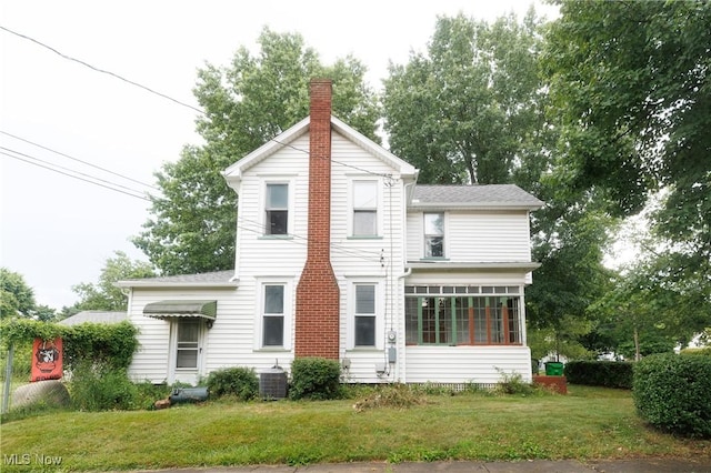625 W Church St, Orrville, OH 44667 - rear view of property with a chimney, a lawn, a shingled roof, and a sunroom