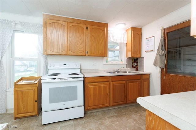 625 W Church St, Orrville, OH 44667 - kitchen featuring white electric stove, light countertops, and brown cabinets