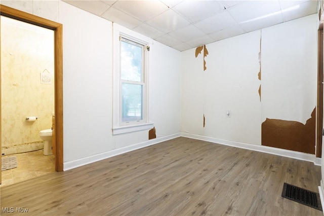 625 W Church St, Orrville, OH 44667 - empty room with a paneled ceiling and wood finished floors