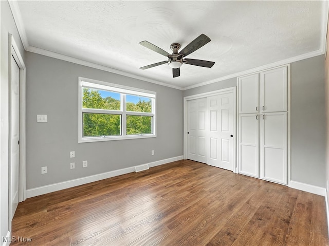 12147 Gladstone Rd SW, North Jackson, OH 44451 - unfurnished bedroom featuring ornamental molding, wood finished floors, and a ceiling fan