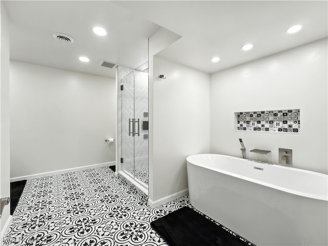 12147 Gladstone Rd SW, North Jackson, OH 44451 - full bath featuring a freestanding bath, a shower stall, recessed lighting, and tile patterned floors