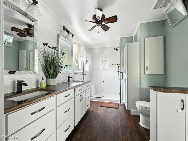 12147 Gladstone Rd SW, North Jackson, OH 44451 - bathroom featuring a ceiling fan, a shower stall, wood finished floors, double vanity, and ornamental molding
