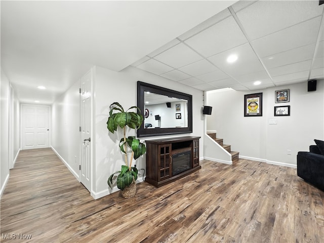 12147 Gladstone Rd SW, North Jackson, OH 44451 - living area with wood finished floors, stairs, recessed lighting, a drop ceiling, and a glass covered fireplace