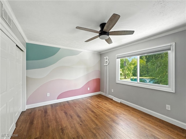 12147 Gladstone Rd SW, North Jackson, OH 44451 - unfurnished room with ornamental molding, a ceiling fan, and wood finished floors