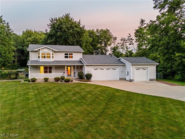 12147 Gladstone Rd SW, North Jackson, OH 44451 - traditional home with a porch, driveway, an attached garage, a lawn, and view of scattered trees