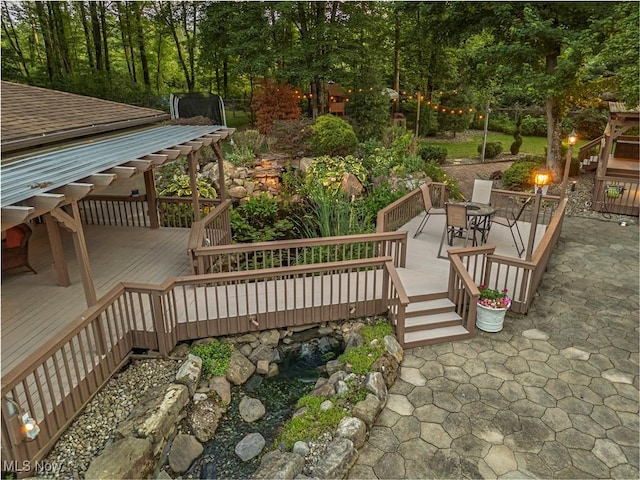 12147 Gladstone Rd SW, North Jackson, OH 44451 - wooden deck with outdoor dining space, stairway, and a patio