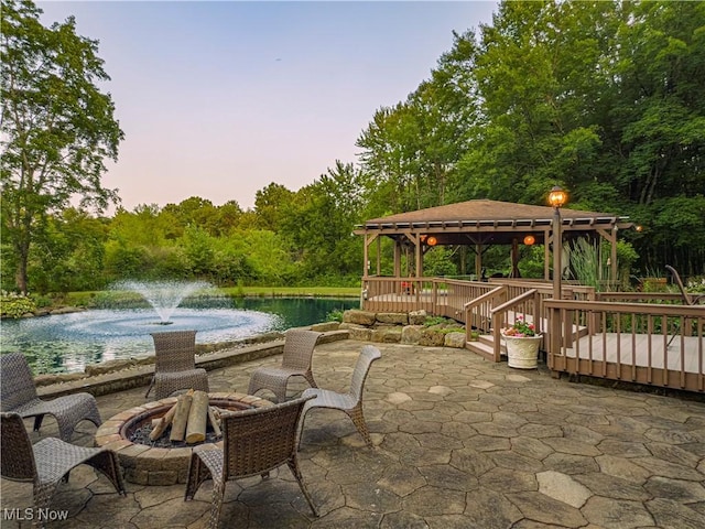 12147 Gladstone Rd SW, North Jackson, OH 44451 - view of patio / terrace with a gazebo, a water view, a fire pit, and a forest view