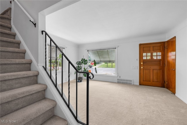 15617 Rockside Rd, Maple Heights, OH 44137 - foyer entrance featuring stairs, plenty of natural light, and carpet floors