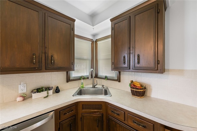 15617 Rockside Rd, Maple Heights, OH 44137 - kitchen with stainless steel dishwasher, light countertops, dark brown cabinetry, and tasteful backsplash