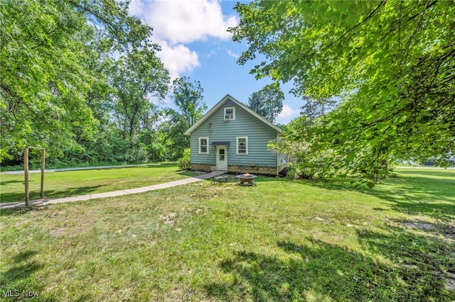 1425 Keefer Rd, Girard, OH 44420 - rear view of house featuring a lawn and an outdoor fire pit