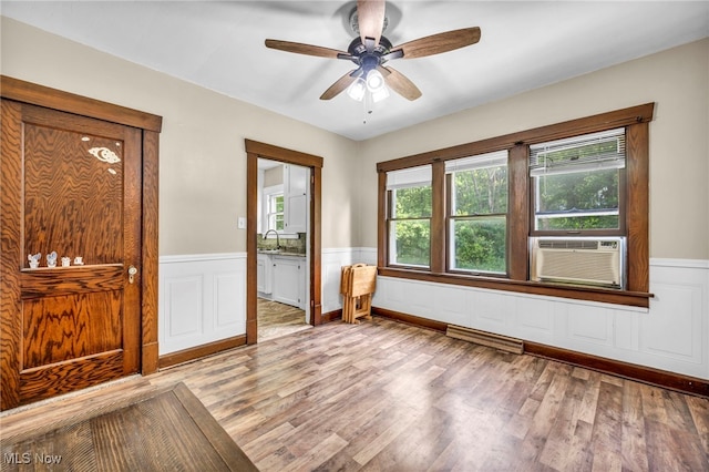 1425 Keefer Rd, Girard, OH 44420 - empty room with cooling unit, wainscoting, a ceiling fan, and light wood-type flooring