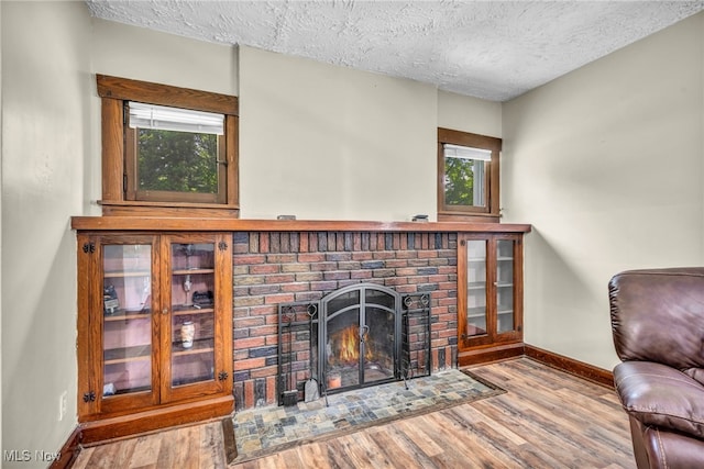 1425 Keefer Rd, Girard, OH 44420 - living room with a textured ceiling, wood finished floors, and a fireplace