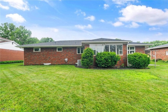 853 Almasy Dr, Campbell, OH 44405 - rear view of house with brick siding and a lawn