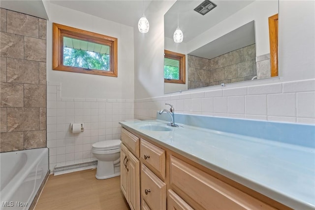 853 Almasy Dr, Campbell, OH 44405 - bathroom featuring tile walls, vanity, a bathtub, wood finished floors, and a shower