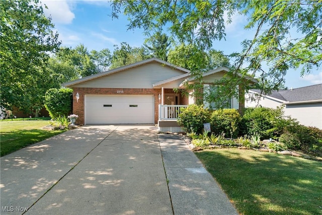 2715 Eastwood Dr, Wooster, OH 44691 - single story home with brick siding, concrete driveway, a front lawn, and an attached garage