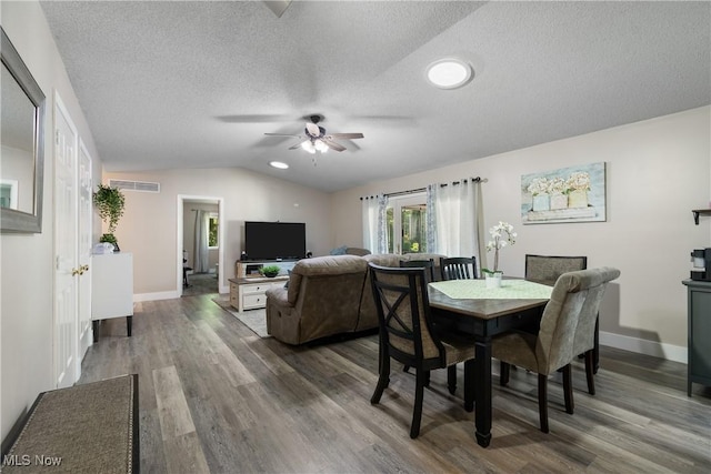 2715 Eastwood Dr, Wooster, OH 44691 - dining space featuring a ceiling fan, wood finished floors, vaulted ceiling, and a textured ceiling