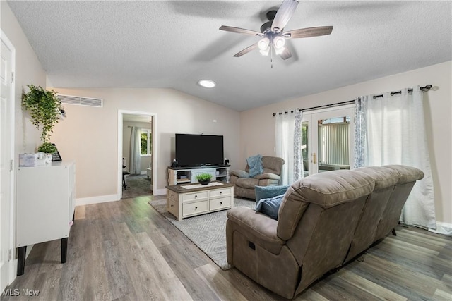 2715 Eastwood Dr, Wooster, OH 44691 - living room featuring lofted ceiling, ceiling fan, wood finished floors, and a textured ceiling