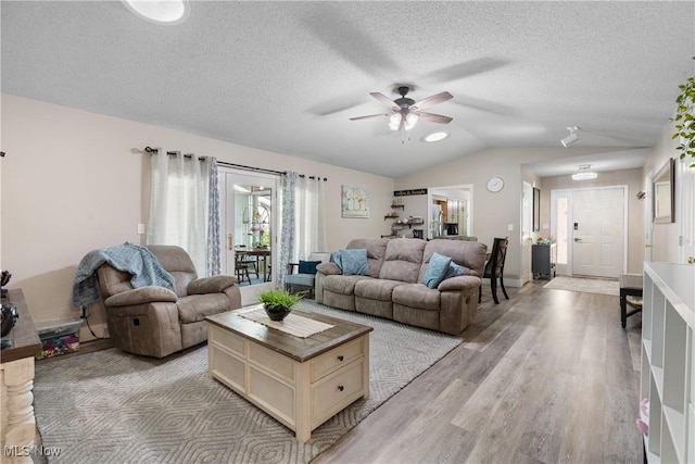 2715 Eastwood Dr, Wooster, OH 44691 - living area featuring a ceiling fan, vaulted ceiling, light wood-style flooring, and a textured ceiling