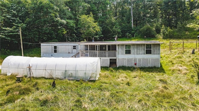 2361 Carpenter Run Rd, Waverly, WV 26184 - manufactured / mobile home featuring an exterior structure, an outdoor structure, and a view of trees