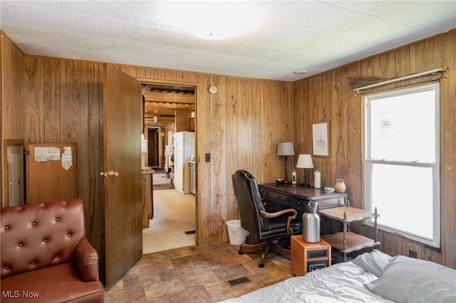 2361 Carpenter Run Rd, Waverly, WV 26184 - bedroom with freestanding refrigerator, wooden walls, and stone finish flooring