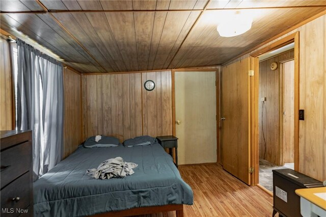 2361 Carpenter Run Rd, Waverly, WV 26184 - bedroom with wooden walls, wood ceiling, and light wood-style flooring