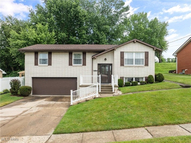4134 Brightway St, Weirton, WV 26062 - raised ranch featuring a garage, driveway, and brick siding
