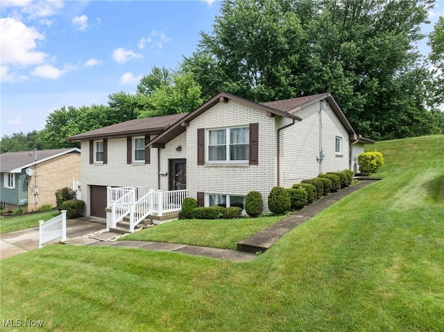 4134 Brightway St, Weirton, WV 26062 - split foyer home featuring concrete driveway, a garage, brick siding, and a front lawn