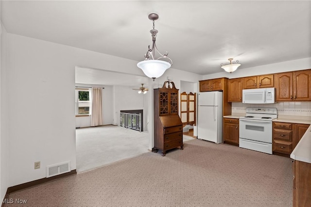 4134 Brightway St, Weirton, WV 26062 - kitchen with white appliances, brown cabinetry, a ceiling fan, light countertops, and decorative light fixtures