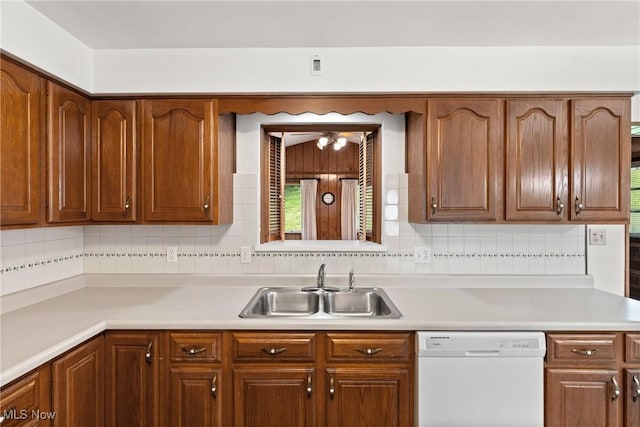 4134 Brightway St, Weirton, WV 26062 - kitchen with white dishwasher, light countertops, decorative backsplash, and brown cabinets