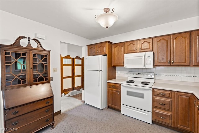 4134 Brightway St, Weirton, WV 26062 - kitchen with white appliances, brown cabinetry, tasteful backsplash, and light countertops