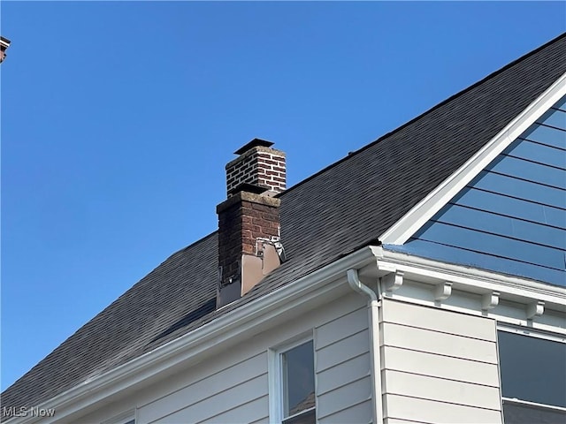 3363 E 125th St, Cleveland, OH 44120 - exterior view of gutters, a chimney, a downspout, and roof with shingles