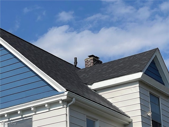 3363 E 125th St, Cleveland, OH 44120 - exterior view of a chimney, gutters, roof with shingles, and a downspout
