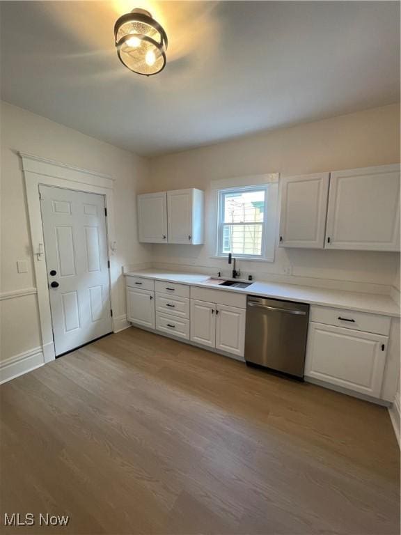 3363 E 125th St, Cleveland, OH 44120 - kitchen with stainless steel dishwasher, white cabinets, and light wood-style floors