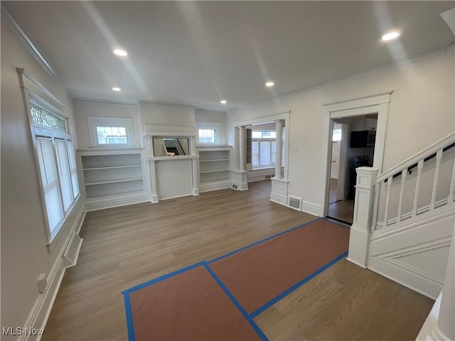 3363 E 125th St, Cleveland, OH 44120 - unfurnished living room featuring crown molding, plenty of natural light, wood finished floors, stairs, and recessed lighting