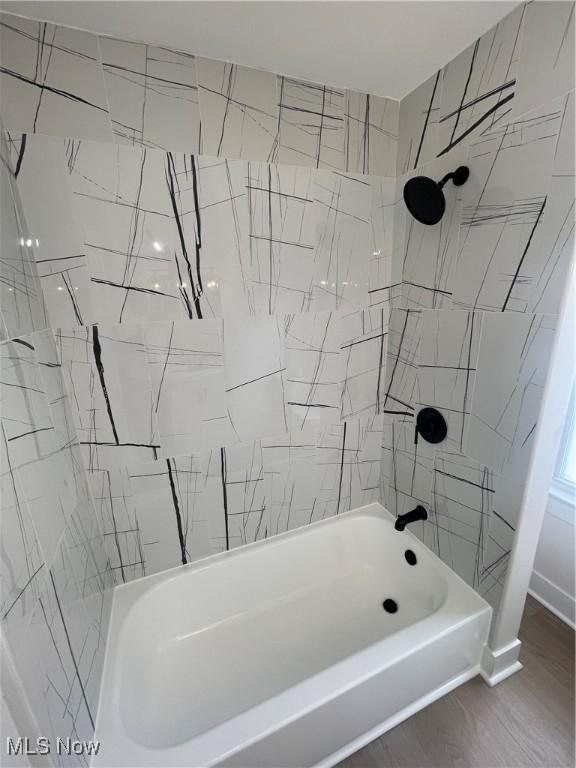 3363 E 125th St, Cleveland, OH 44120 - bathroom featuring shower / bathtub combination and wood finished floors